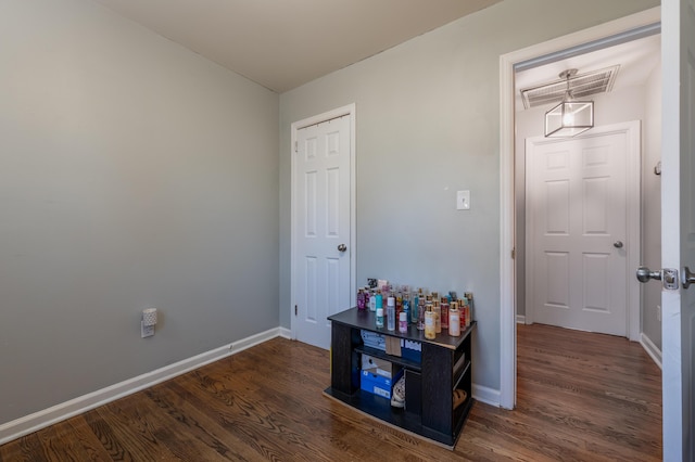 hall featuring dark wood-style floors and baseboards
