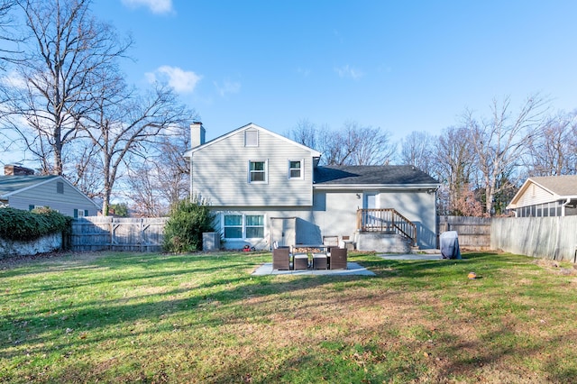 rear view of property with a chimney and a patio