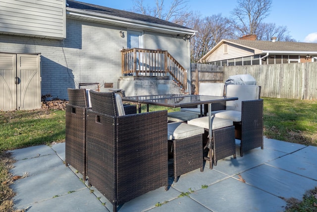 view of patio with outdoor dining space and fence