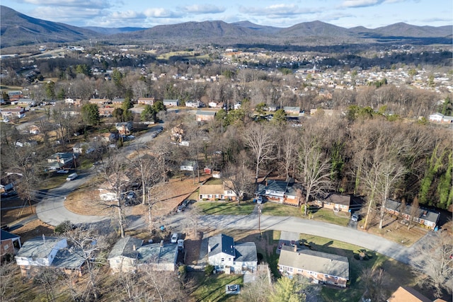 aerial overview of property's location featuring a mountainous background and nearby suburban area