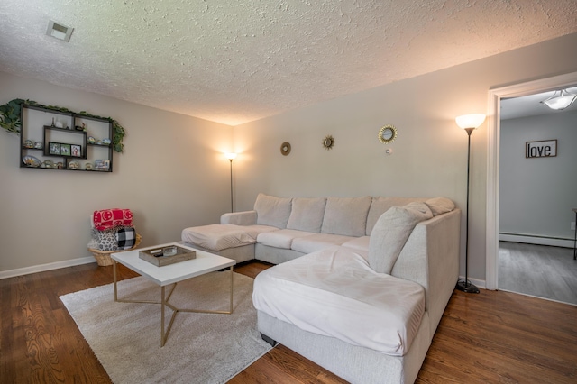 living room with a textured ceiling, a baseboard radiator, wood finished floors, and baseboards