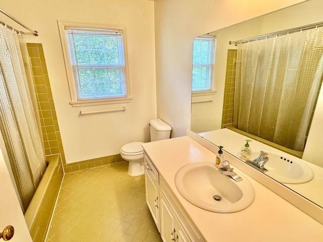 full bath with tile patterned flooring, a wealth of natural light, toilet, and vanity