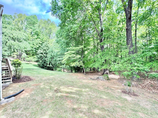 view of yard featuring stairway and a forest view