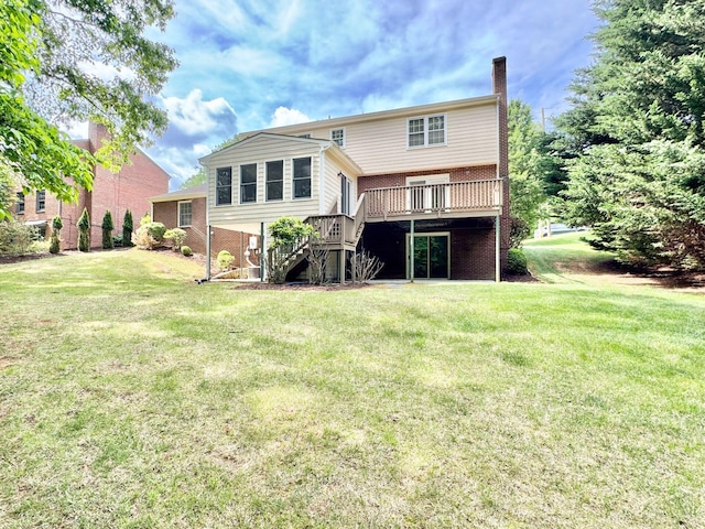back of house with a chimney, a lawn, a deck, brick siding, and stairs