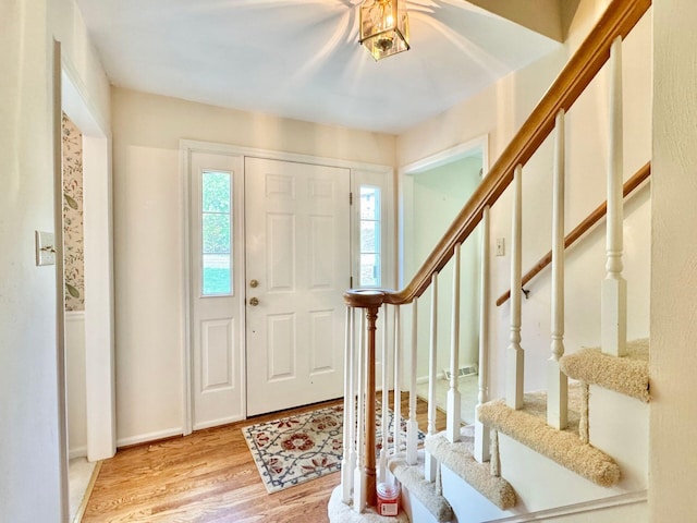 foyer with stairway and light wood-style floors