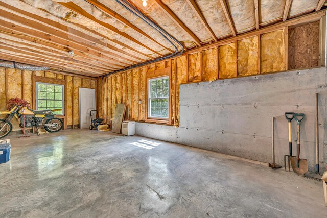 interior space featuring a garage and unfinished concrete floors