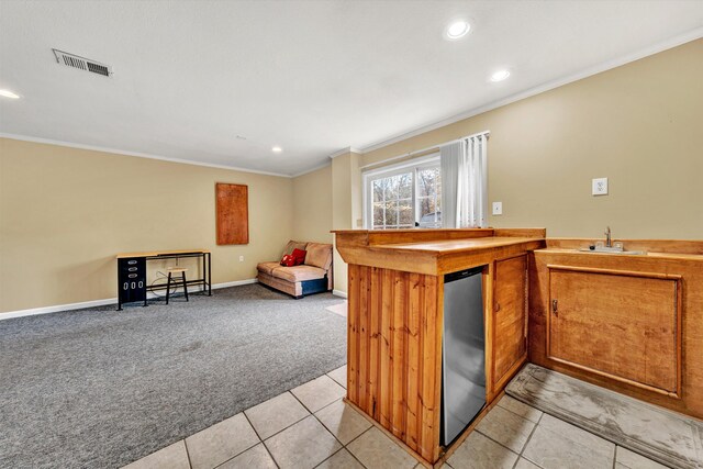 kitchen with crown molding, recessed lighting, visible vents, and light carpet
