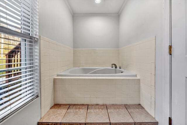 bathroom featuring crown molding, tile patterned flooring, plenty of natural light, and a garden tub