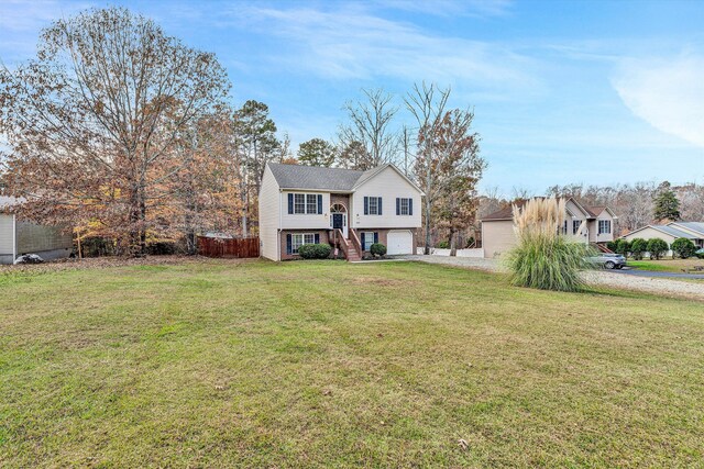 view of front of home with a garage, stairs, driveway, and a front yard