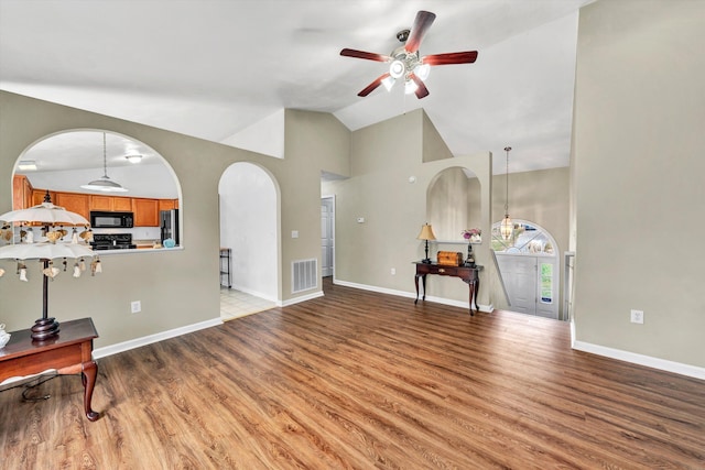 260 Harbor Landing Dr, Moneta, VA 24121 - living area with high vaulted ceiling, ceiling fan, light wood-type flooring, arched walkways, and baseboards