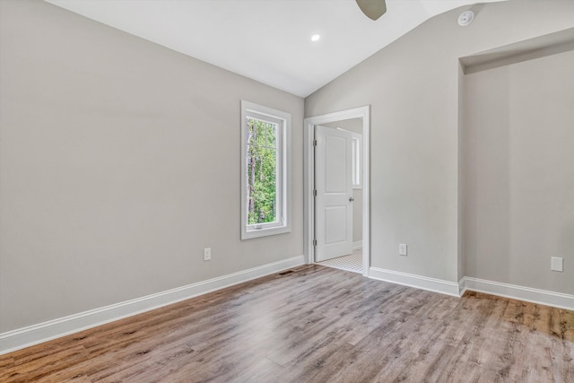 unfurnished room featuring ceiling fan, wood finished floors, baseboards, lofted ceiling, and recessed lighting