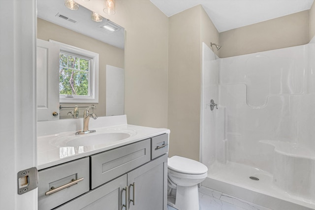 bathroom with walk in shower, vanity, toilet, marble finish floor, and visible vents
