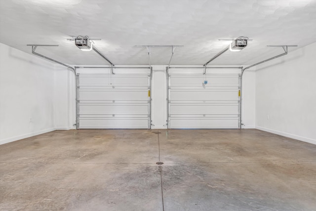 garage featuring baseboards and a garage door opener