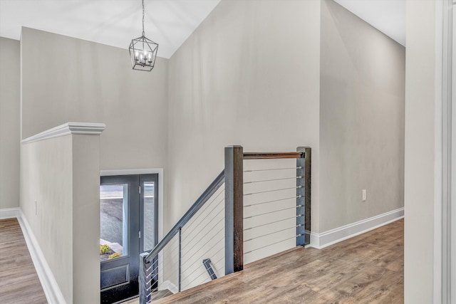 entryway featuring an inviting chandelier, baseboards, and wood finished floors