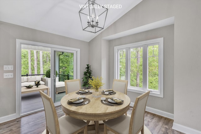 dining room featuring baseboards, vaulted ceiling, and a wealth of natural light