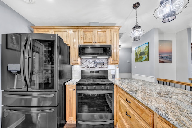 kitchen with stainless steel range with gas stovetop, backsplash, black fridge with ice dispenser, and light stone counters
