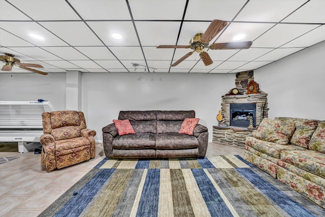 tiled living area featuring ceiling fan and a paneled ceiling