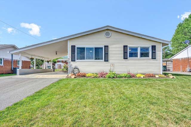 ranch-style house featuring driveway, a front yard, and an attached carport