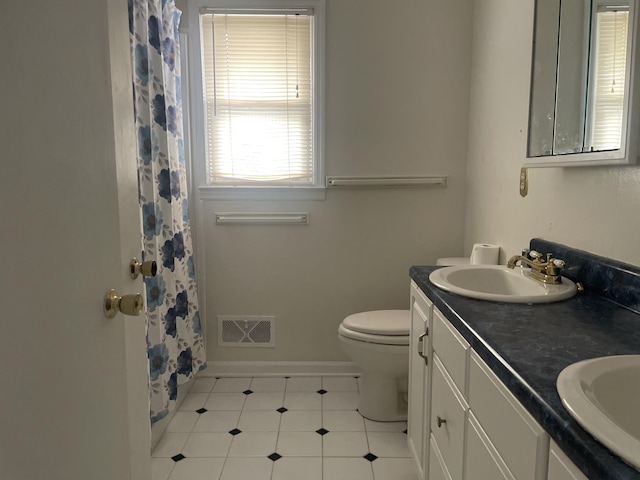 1508 Jefferson Ave, Clifton Forge, VA 24422 - full bath with toilet, double vanity, baseboards, curtained shower, and tile patterned flooring