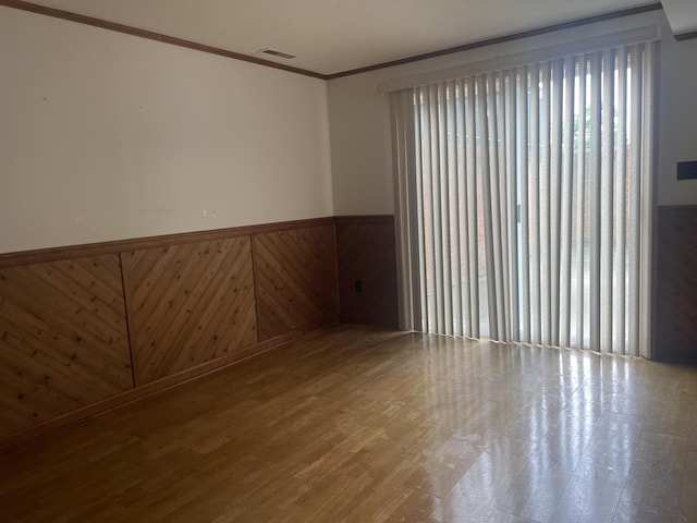 1508 Jefferson Ave, Clifton Forge, VA 24422 - spare room with a wainscoted wall, crown molding, and wood finished floors