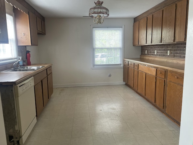 1508 Jefferson Ave, Clifton Forge, VA 24422 - kitchen featuring dishwasher, a sink, baseboards, decorative backsplash, and a chandelier