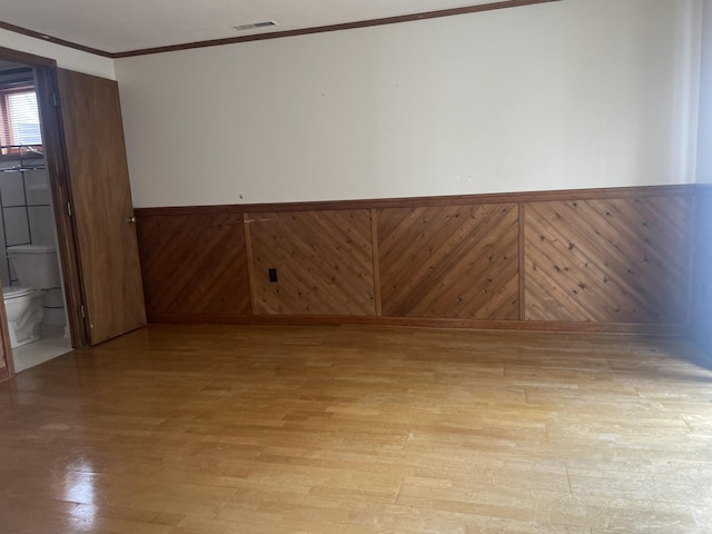 1508 Jefferson Ave, Clifton Forge, VA 24422 - empty room with wainscoting, light wood-type flooring, and crown molding