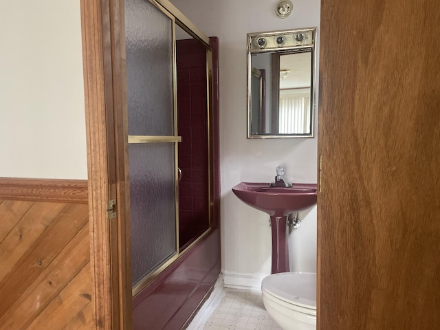 1508 Jefferson Ave, Clifton Forge, VA 24422 - bathroom featuring toilet, shower / bath combination with glass door, and baseboards