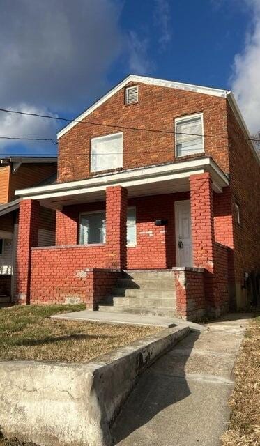 711 Mcdowell Ave NW, Roanoke, VA 24016 - rear view of house featuring a porch and brick siding