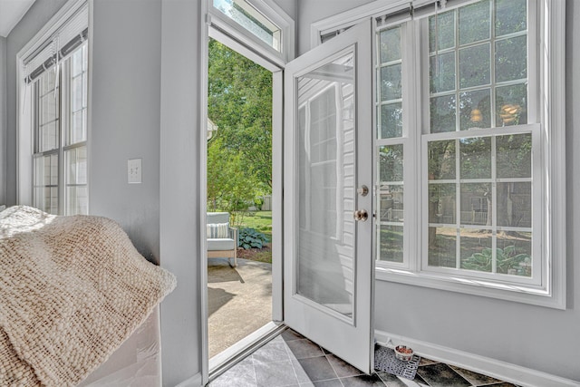 doorway featuring baseboards