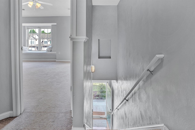 stairs with baseboards, carpet flooring, and ceiling fan