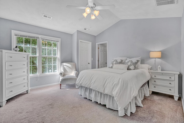 carpeted bedroom featuring visible vents, baseboards, ceiling fan, and vaulted ceiling