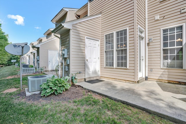 entrance to property featuring cooling unit