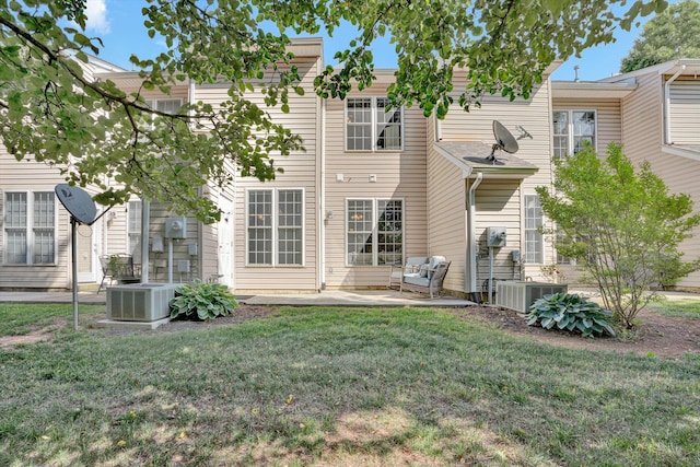 rear view of property with a patio, a yard, and central AC unit