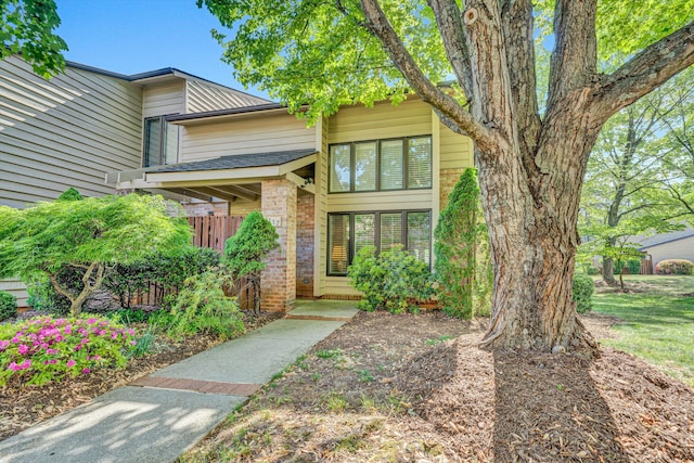 entrance to property featuring brick siding