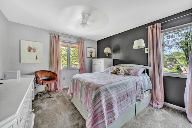 bedroom featuring baseboards, ceiling fan, and light colored carpet