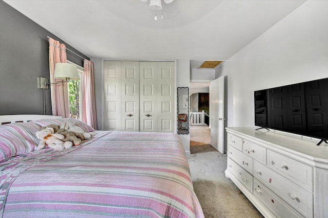 bedroom with light carpet and a closet