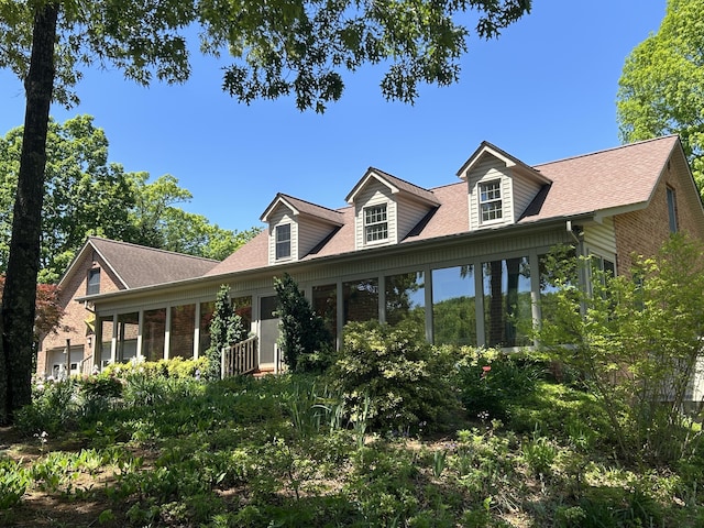5531 Bethlehem Rd, Boones Mill, VA 24065 - view of front facade with a sunroom, brick siding, and roof with shingles