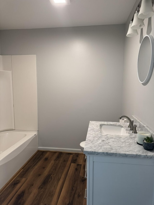 3779 Old Franklin Tpke, Glade Hill, VA 24092 - full bath featuring vanity, toilet, baseboards, shower / bath combination, and wood finished floors