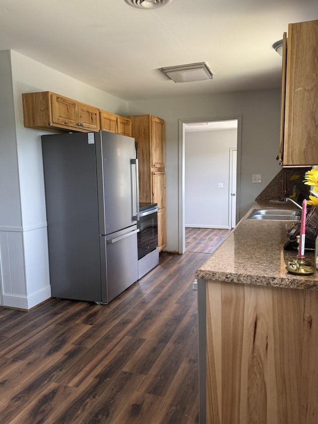 3779 Old Franklin Tpke, Glade Hill, VA 24092 - kitchen with brown cabinets, dark countertops, a sink, stainless steel appliances, and dark wood-type flooring