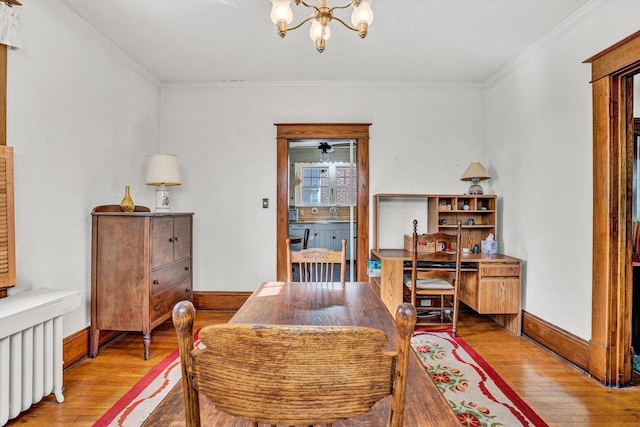 2226 Wycliffe Ave SW, Roanoke, VA 24014 - dining room with light wood-type flooring, crown molding, a chandelier, baseboards, and radiator heating unit