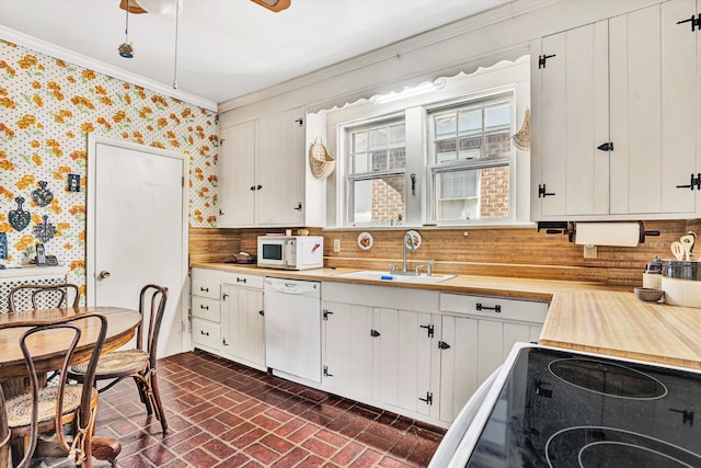 2226 Wycliffe Ave SW, Roanoke, VA 24014 - kitchen with white appliances, brick patterned floors, a sink, wallpapered walls, and crown molding