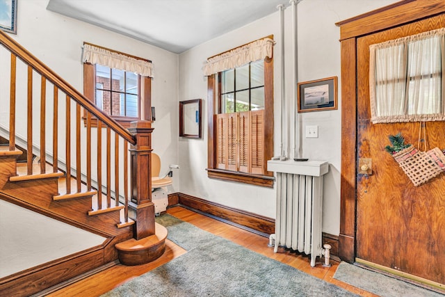 2226 Wycliffe Ave SW, Roanoke, VA 24014 - foyer featuring radiator heating unit, healthy amount of natural light, wood finished floors, and baseboards