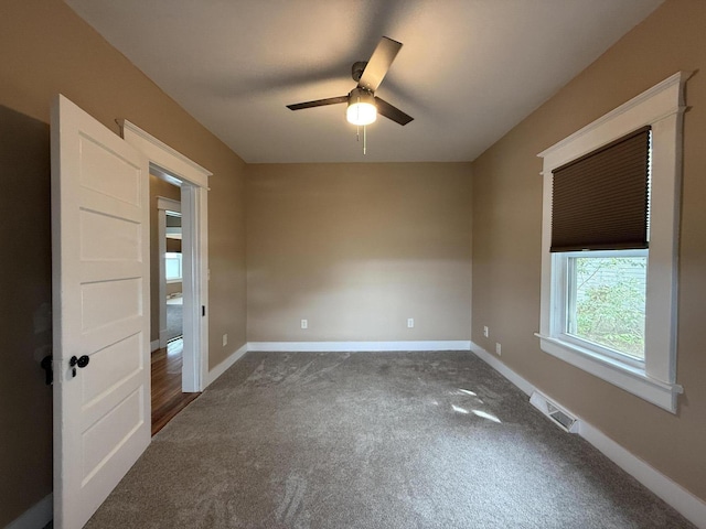 1518 Tazewell Ave SE, Roanoke, VA 24013 - spare room with dark carpet, ceiling fan, and baseboards