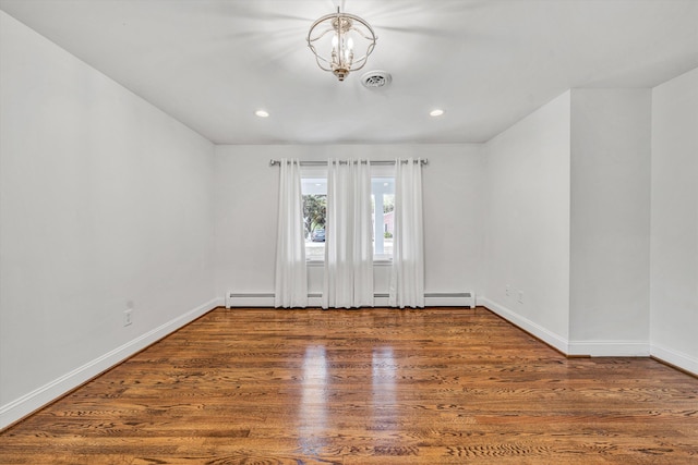 unfurnished room with wood finished floors, baseboards, recessed lighting, and a chandelier