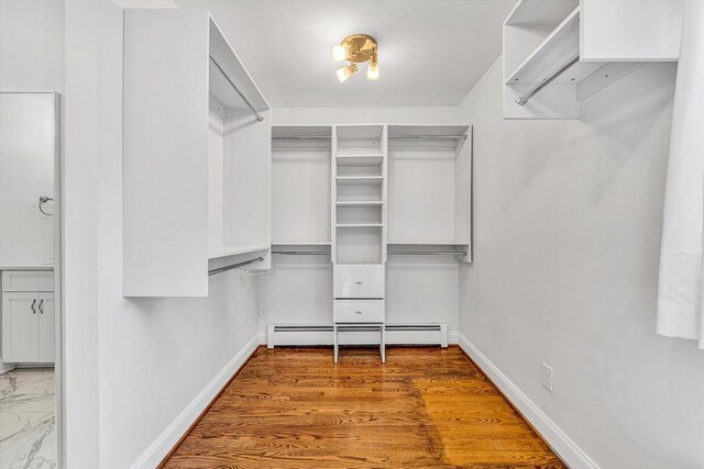 spacious closet featuring a baseboard heating unit