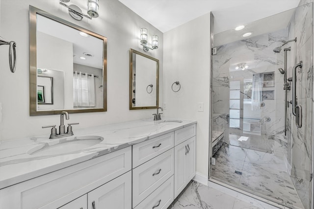 full bath with marble look tiles, a marble finish shower, double vanity, recessed lighting, and baseboards