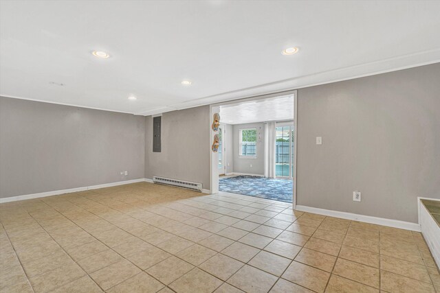 empty room with a baseboard heating unit, light tile patterned floors, recessed lighting, electric panel, and baseboards