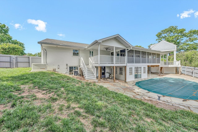 back of house with a sunroom, stairway, a ceiling fan, a patio area, and a deck