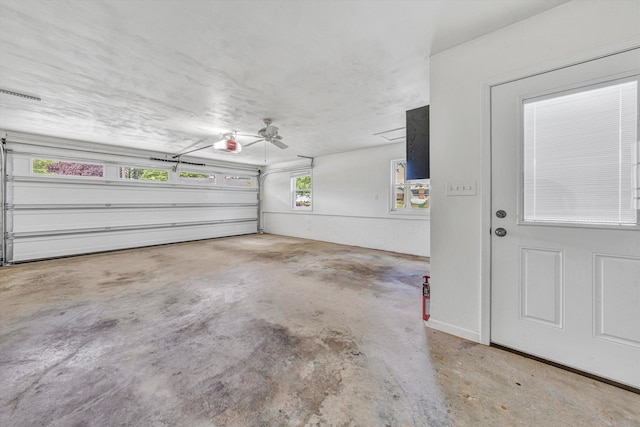 garage featuring a garage door opener and a ceiling fan
