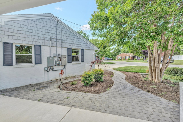 view of side of home with brick siding